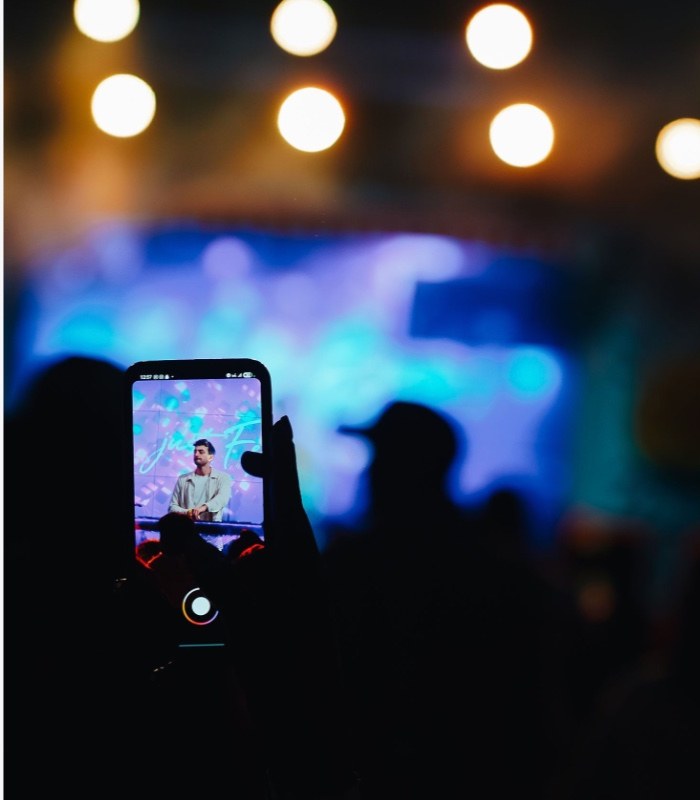A fan filming the show